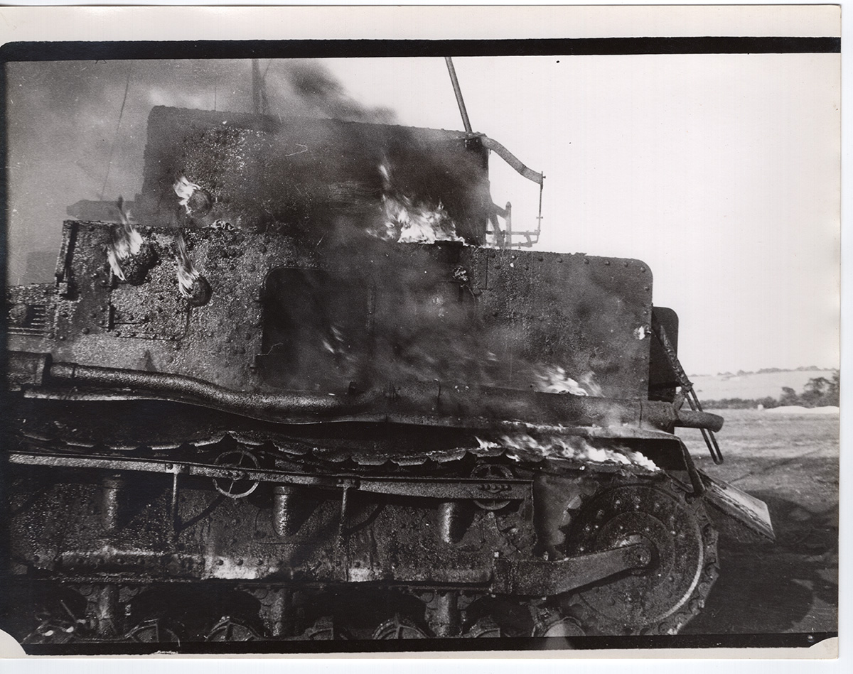 Collections Fraser Flamethrower Burning Vickers Wreck Black and white photograph from the early 1940s showing the burning wreck of a tank, used as a target during trials of experimental flamethrower weapons.