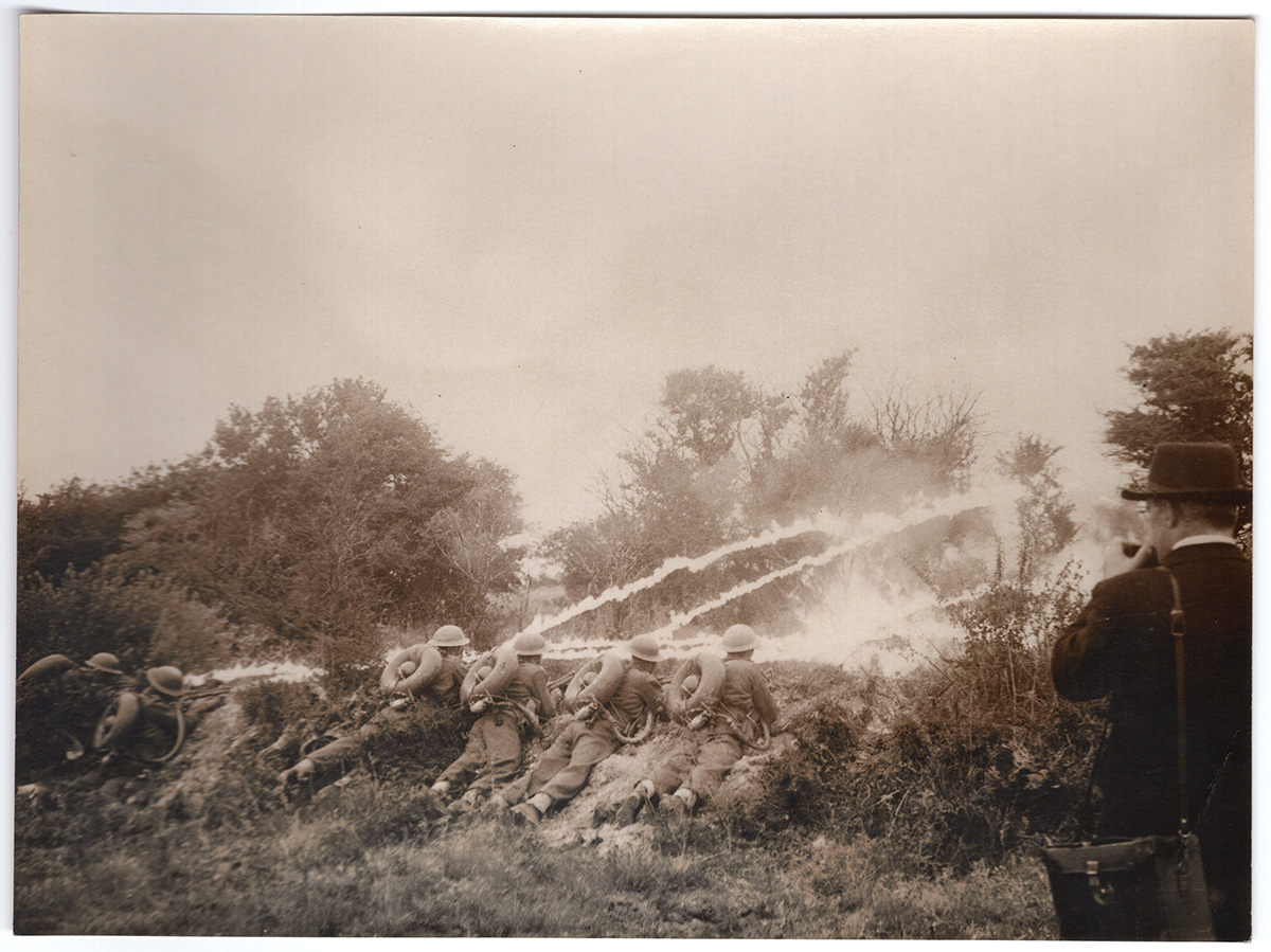 Collections Fraser Flamethrower Lifebuoy Trials Black and white photograph from the early 1940s - showing a group of men firing experimental man-portable flamethrower devices.