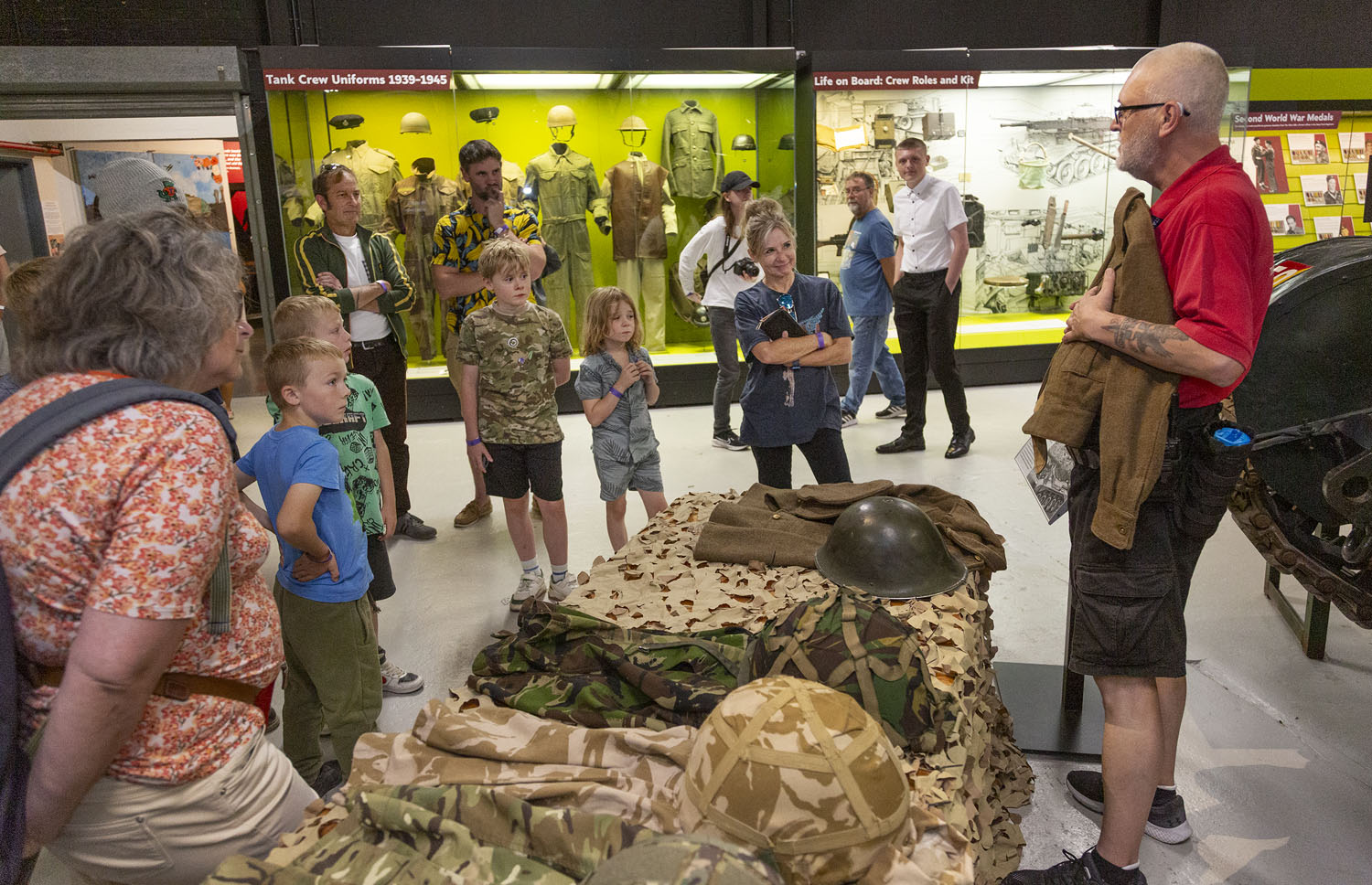 Visitors Summer 2025_170 a group of visitors looking at tank crew uniform demonstration