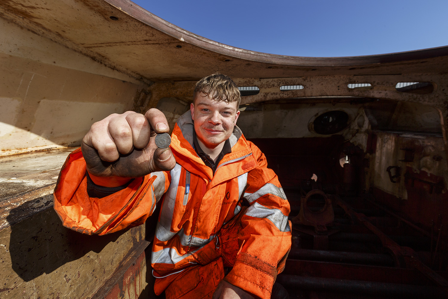 James with coin Workshop apprentice holding a german WWII coin inside King Tiger